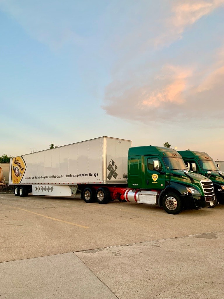 Palletized Trucking dry van fleet at sunset